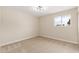 Bright bedroom with neutral carpet, light walls, and a window offering natural light at 5313 W Osborn Rd, Phoenix, AZ 85031