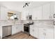 Modern kitchen featuring white cabinets, stainless steel appliances, and a stylish backsplash at 5313 W Osborn Rd, Phoenix, AZ 85031