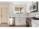 Bright kitchen with white cabinets, stainless steel appliances, and a window view at 5313 W Osborn Rd, Phoenix, AZ 85031