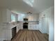 Bright kitchen boasts white cabinets, stainless steel appliances, and modern backsplash at 5313 W Osborn Rd, Phoenix, AZ 85031