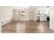 Spacious living room featuring wood flooring, natural light and adjacent modern kitchen at 5313 W Osborn Rd, Phoenix, AZ 85031