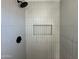 Clean shower with built-in shelves and modern fixtures at 5313 W Osborn Rd, Phoenix, AZ 85031