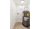 Utility room with a water heater, laminate flooring, and white walls at 5313 W Osborn Rd, Phoenix, AZ 85031