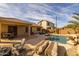 Spacious backyard with pool, lounge chairs, and fire pit at 6238 W Buckhorn Trl, Phoenix, AZ 85083