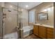 Bathroom with shower, bathtub, and wooden vanity at 6238 W Buckhorn Trl, Phoenix, AZ 85083