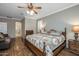 Main bedroom with wooden bed frame and en-suite bathroom at 6238 W Buckhorn Trl, Phoenix, AZ 85083