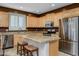 Kitchen with light wood cabinets, granite countertops, and stainless steel appliances at 6238 W Buckhorn Trl, Phoenix, AZ 85083