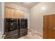 Laundry room with modern washer and dryer, and cabinets at 6238 W Buckhorn Trl, Phoenix, AZ 85083