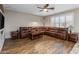 Spacious living room with hardwood floors and a large sectional sofa at 6238 W Buckhorn Trl, Phoenix, AZ 85083