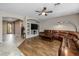 Open living room with hardwood floors, built-in shelving, and a sectional sofa at 6238 W Buckhorn Trl, Phoenix, AZ 85083