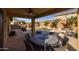 Relaxing covered patio with outdoor dining set and pool view at 6238 W Buckhorn Trl, Phoenix, AZ 85083