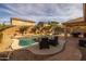 Relaxing backyard pool with patio furniture and landscaping at 6238 W Buckhorn Trl, Phoenix, AZ 85083