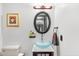 Powder room with a vessel sink, oval mirror, and warm lighting at 6811 E Juniper Ave, Scottsdale, AZ 85254