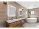 Modern bathroom with dual sinks, a standalone tub, and stylish tile work at 6811 E Juniper Ave, Scottsdale, AZ 85254