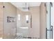 Shower and tub area with glass enclosure, rain shower head, and elegant tile details at 6811 E Juniper Ave, Scottsdale, AZ 85254