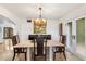 Beautiful dining room with a decorative chandelier and a view of the lush outdoor space at 6811 E Juniper Ave, Scottsdale, AZ 85254