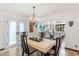 Elegant dining room with stone table, stylish chairs, and view into the living room at 6811 E Juniper Ave, Scottsdale, AZ 85254