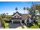 Beautiful two-story home featuring mature trees, a two car garage, and a lush green lawn at 6811 E Juniper Ave, Scottsdale, AZ 85254