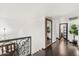 Upstairs hallway with dark floors and iron railing at 6811 E Juniper Ave, Scottsdale, AZ 85254