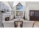 Bright living room with a large window, stone fireplace, and comfortable seating at 6811 E Juniper Ave, Scottsdale, AZ 85254