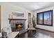 Cozy living room showcasing a charming fireplace, comfortable chairs and view to the outside at 6811 E Juniper Ave, Scottsdale, AZ 85254