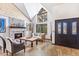 Inviting living room with a cozy fireplace, travertine floors, and soaring ceilings at 6811 E Juniper Ave, Scottsdale, AZ 85254