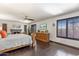 Spacious main bedroom with dark wood floors, fireplace, and plenty of natural light at 6811 E Juniper Ave, Scottsdale, AZ 85254