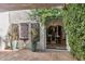 Inviting outdoor patio with greenery and a glimpse into the dining room through an open door at 6811 E Juniper Ave, Scottsdale, AZ 85254