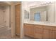 Well-lit bathroom featuring double sink vanity, storage, and a separate toilet and shower area at 7027 N Scottsdale Rd # 150, Paradise Valley, AZ 85253