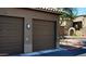 Attached two-car garage with automatic doors and exterior lighting at 7027 N Scottsdale Rd # 150, Paradise Valley, AZ 85253