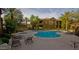 Community pool with sun loungers, spa, and lush landscaping at 7027 N Scottsdale Rd # 150, Paradise Valley, AZ 85253