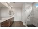 Bathroom with double vanity, marble shower, and dark floor tiles at 7163 W Oberlin Way, Peoria, AZ 85383