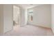 Bedroom featuring neutral carpet, white walls and a door that leads to the bathroom at 7163 W Oberlin Way, Peoria, AZ 85383