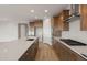 Modern kitchen with island, stainless steel appliances, and wood cabinets at 7163 W Oberlin Way, Peoria, AZ 85383