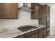 A well-equipped kitchen featuring granite counters, stainless appliances and dark wood cabinets at 7163 W Oberlin Way, Peoria, AZ 85383