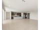 An open concept living room and kitchen with light tile floors and many recessed lights at 7163 W Oberlin Way, Peoria, AZ 85383