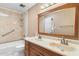 Bathroom featuring double sinks, shower/tub combo, and tiled floors at 7714 E Mariposa Dr, Scottsdale, AZ 85251