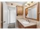 Clean bathroom with wood vanity and large mirror at 7714 E Mariposa Dr, Scottsdale, AZ 85251