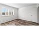 Light-filled bedroom featuring wood-look floors and window shutters at 7714 E Mariposa Dr, Scottsdale, AZ 85251