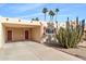 Single level home with covered carport and red door at 7714 E Mariposa Dr, Scottsdale, AZ 85251