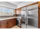 Stainless steel appliances and wood cabinets in kitchen at 7714 E Mariposa Dr, Scottsdale, AZ 85251