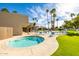 Community pool and spa area with lounge chairs and palm trees at 7714 E Mariposa Dr, Scottsdale, AZ 85251