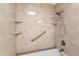 Clean shower with tiled walls and built-in shelves at 7714 E Mariposa Dr, Scottsdale, AZ 85251