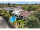 Aerial view of a home with a sparkling pool, covered patio, and well-maintained landscaping in a desirable neighborhood at 9504 E Sunnyside Dr, Scottsdale, AZ 85260