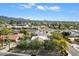 Aerial view of a residence featuring a pool, lush greenery, and mountain views in the distance at 9504 E Sunnyside Dr, Scottsdale, AZ 85260