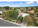 Elevated street view of a house showcasing mature trees, landscaped yard, and well-maintained surroundings at 9504 E Sunnyside Dr, Scottsdale, AZ 85260