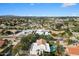 Panoramic aerial shot of a suburban neighborhood with a home featuring a pool, lush landscaping, and mountain views at 9504 E Sunnyside Dr, Scottsdale, AZ 85260