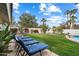 Inviting backyard featuring lush lawn, lounge chairs, and mature trees, perfect for relaxation and entertaining at 9504 E Sunnyside Dr, Scottsdale, AZ 85260