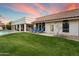 Expansive backyard featuring lush lawn, covered patio and outdoor seating, perfect for entertaining at 9504 E Sunnyside Dr, Scottsdale, AZ 85260