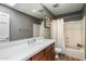 Bathroom featuring a wood vanity with a white sink, toilet, and shower/tub combo at 9504 E Sunnyside Dr, Scottsdale, AZ 85260